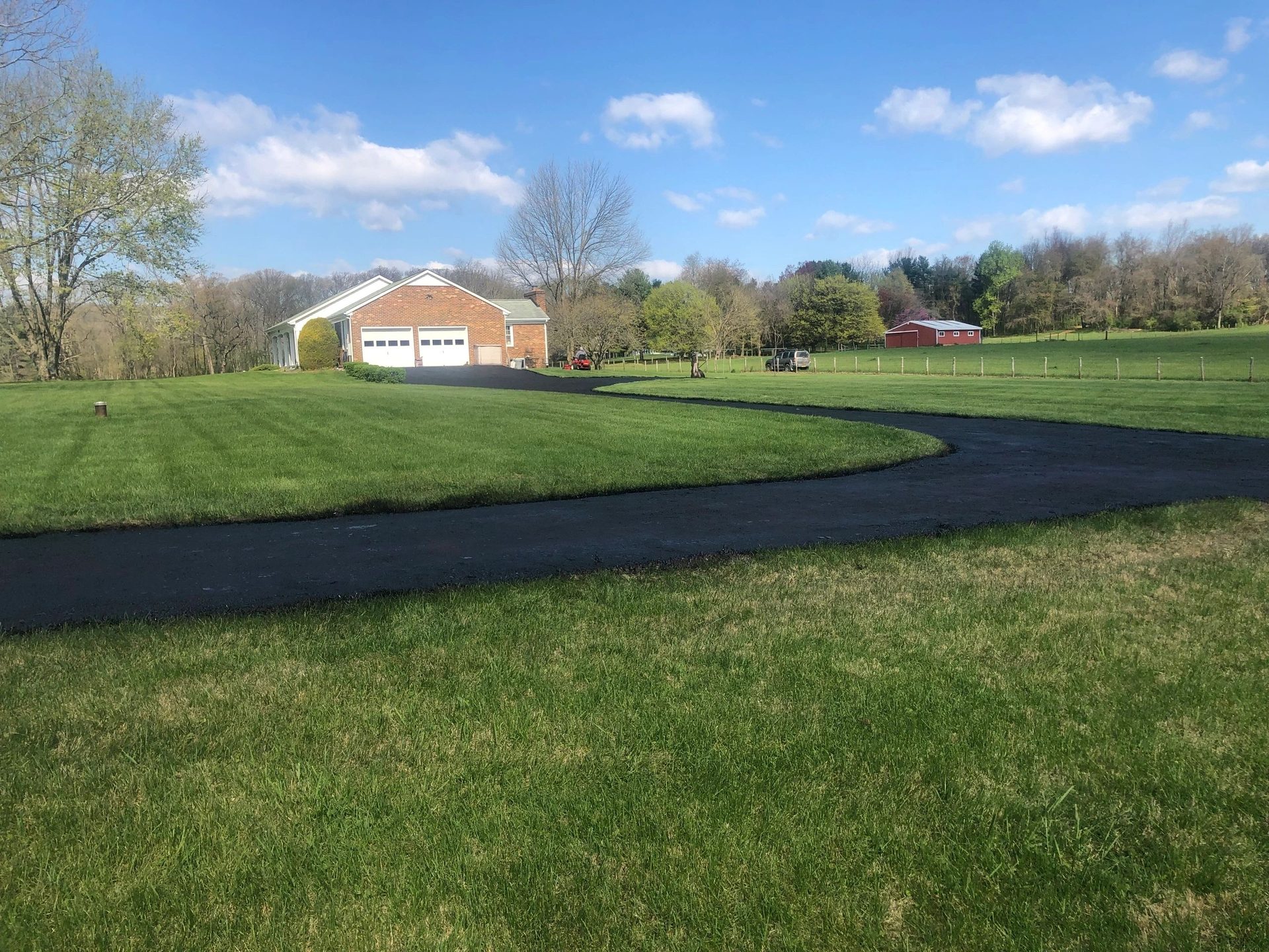 Long curved driveway surfaced with asphalt millings